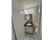 Compact bathroom features a granite vanity, mirror, decorative lighting, and toilet at 3530 Forest Branch Dr # F, Port Orange, FL 32129