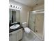 A well-lit bathroom offers a shower with sliding doors, a toilet, and granite topped vanity at 3530 Forest Branch Dr # F, Port Orange, FL 32129