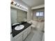 A full bathroom with walk in tub, granite counters, tile floors and ample lighting at 3530 Forest Branch Dr # F, Port Orange, FL 32129
