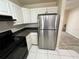 Kitchen with stainless steel appliances, white cabinetry and hard floors at 3530 Forest Branch Dr # F, Port Orange, FL 32129