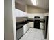 A Kitchen features new appliances, tile floor and white cabinets at 3530 Forest Branch Dr # F, Port Orange, FL 32129