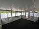 Enclosed lanai with wall-to-wall windows, black carpet and access to back yard at 3530 Forest Branch Dr # F, Port Orange, FL 32129