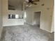 Open-concept living area featuring plush carpeting, a ceiling fan, and views into adjacent rooms at 3530 Forest Branch Dr # F, Port Orange, FL 32129