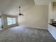 Bright living room features a ceiling fan, large windows and new carpet at 3530 Forest Branch Dr # F, Port Orange, FL 32129