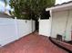 Enclosed patio area showcasing a white fence and stone-patterned patio surface at 3530 Forest Branch Dr # F, Port Orange, FL 32129