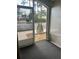 View from enclosed porch of a parking area with trees in the distance at 3530 Forest Branch Dr # F, Port Orange, FL 32129