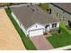 New construction home with gray roof and driveway, and lawn at 364 Lemongrass Rd, Minneola, FL 34715