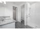 Bright bathroom featuring a double vanity with granite countertop and a glass-enclosed shower at 364 Lemongrass Rd, Minneola, FL 34715