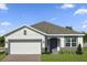 Charming single-Gathering home boasts a two-car garage and a well-manicured lawn at 364 Lemongrass Rd, Minneola, FL 34715