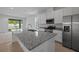 Modern kitchen featuring stainless steel appliances, granite countertops and island at 364 Lemongrass Rd, Minneola, FL 34715