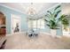 Bright breakfast nook featuring a modern chandelier, travertine floors and floor to ceiling windows at 4 Island Dr, Lake Mary, FL 32746