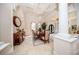 Open-concept dining area featuring a chandelier, travertine floors, arched entryways and designer furnishings at 4 Island Dr, Lake Mary, FL 32746