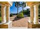 Elegant brick driveway framed by stone pillars and lush greenery, leading to a beautiful home at 4 Island Dr, Lake Mary, FL 32746