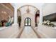 Elegant foyer with tile flooring, ornate chandelier, and arched doorways, offering a grand entrance at 4 Island Dr, Lake Mary, FL 32746