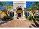 Grand entrance featuring stone columns and arched doorway, surrounded by lush landscaping and a brick driveway at 4 Island Dr, Lake Mary, FL 32746