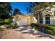 Charming garage with brick driveway, set against a backdrop of manicured landscaping and a clear blue sky at 4 Island Dr, Lake Mary, FL 32746