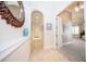 Hallway with tile flooring, decorative mirror, and access to a bedroom at 4 Island Dr, Lake Mary, FL 32746