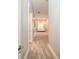 Long hallway with neutral-colored walls and carpet that leads to the bright sunroom at 4 Island Dr, Lake Mary, FL 32746