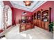 This home office features custom wood built-ins, coffered ceilings and an executive desk at 4 Island Dr, Lake Mary, FL 32746