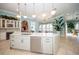 An open-concept kitchen with a large island, pendant lighting, and stainless steel appliances at 4 Island Dr, Lake Mary, FL 32746