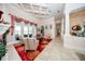 An open-concept living area featuring travertine floors, arched entryways, and access to outdoor patio at 4 Island Dr, Lake Mary, FL 32746