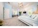 A sunlit main bedroom featuring plush carpeting, a ceiling fan, and neutral walls, offering a serene retreat at 4 Island Dr, Lake Mary, FL 32746