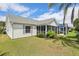 Well-maintained backyard featuring lush green lawn and an attached screened patio at 433 Arcadia Lakes Dr, The Villages, FL 32162