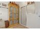 Bathroom featuring light wood cabinetry, a tiled floor, and a separate shower with glass door at 433 Arcadia Lakes Dr, The Villages, FL 32162