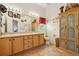 Bathroom featuring double sinks, light wood cabinetry, a soaking tub, and a separate shower with glass door at 433 Arcadia Lakes Dr, The Villages, FL 32162