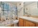 Cozy bathroom featuring a vanity with wood cabinets and a shower with a decorative nautical curtain at 433 Arcadia Lakes Dr, The Villages, FL 32162