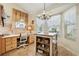 Eat-in kitchen featuring tiled floors, a desk area, and a light fixture over a small wooden table with stools at 433 Arcadia Lakes Dr, The Villages, FL 32162