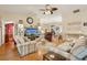 Comfortable living room with hardwood floors, stylish decor, and an open layout that enhances the home's appeal at 433 Arcadia Lakes Dr, The Villages, FL 32162