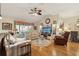 Bright living room boasts hardwood floors, cozy seating, and a large window for natural light at 433 Arcadia Lakes Dr, The Villages, FL 32162