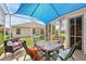 Covered patio with stylish seating area, perfect for relaxing and enjoying the outdoor space at 433 Arcadia Lakes Dr, The Villages, FL 32162