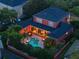 Aerial view of a home with a backyard oasis, including a pool, spa, outdoor seating, and mature landscaping at 4350 New Broad St, Orlando, FL 32814