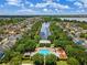 Aerial view showcasing community pool, playground, homes, and a serene lake surrounded by lush landscaping at 4350 New Broad St, Orlando, FL 32814