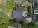 Aerial view of a large home with a kidney-shaped pool, spa, outdoor seating, and mature landscaping at 4350 New Broad St, Orlando, FL 32814