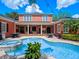 A backyard with a covered patio, a pool, and lush landscaping at 4350 New Broad St, Orlando, FL 32814