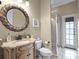 A well-lit bathroom features a vanity with granite countertop, stylish mirror, and glass enclosed shower at 4350 New Broad St, Orlando, FL 32814