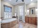 A traditionally styled bathroom featuring a soaking tub, shuttered windows, and granite countertops at 4350 New Broad St, Orlando, FL 32814