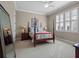 This bedroom features a four poster bed, carpet, bedside tables with lamps, and plantation shutters at 4350 New Broad St, Orlando, FL 32814