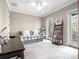 A bedroom featuring a daybed, french doors, and a desk with a dark finish at 4350 New Broad St, Orlando, FL 32814
