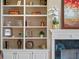 Close up of a built in bookshelf with decorations next to a fireplace at 4350 New Broad St, Orlando, FL 32814