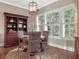 Breakfast nook area with a round wood table, wicker chairs, wood floors and natural light at 4350 New Broad St, Orlando, FL 32814