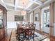 Traditional dining room featuring coffered ceilings, a large window, and stylish chandelier at 4350 New Broad St, Orlando, FL 32814