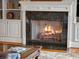 Close up of a granite fireplace with a burning fire at 4350 New Broad St, Orlando, FL 32814