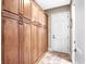 Long hallway with wood cabinets running along one side and a white door on either end at 4350 New Broad St, Orlando, FL 32814