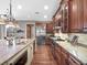 Gourmet kitchen with custom wood cabinetry, stainless steel appliances, and granite countertops at 4350 New Broad St, Orlando, FL 32814