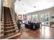Open-concept living space with staircase, fireplace, and multiple French doors, creating a bright atmosphere at 4350 New Broad St, Orlando, FL 32814