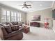 The comfortable living room features a ceiling fan, a large window with shutters and classic furnishings at 4350 New Broad St, Orlando, FL 32814